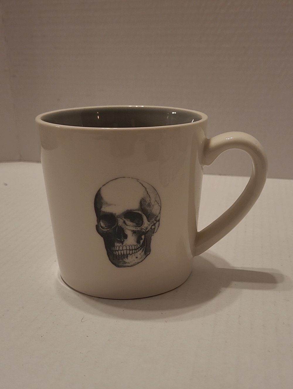 MAGENTA GOTH Cream Ceramic Mug with Skull Design - Neutral Interior